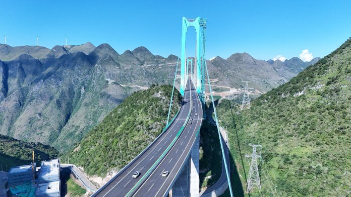 China opens world's reported largest span bridge over Beipan River valley to traffic