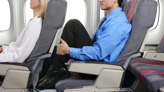 Viral airplane sleep trend sparks safety concerns as passengers pull feet onto seats