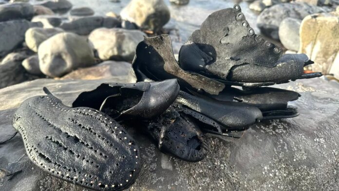 Mysterious batch of old shoes wash up on Wales beach, puzzling local officials