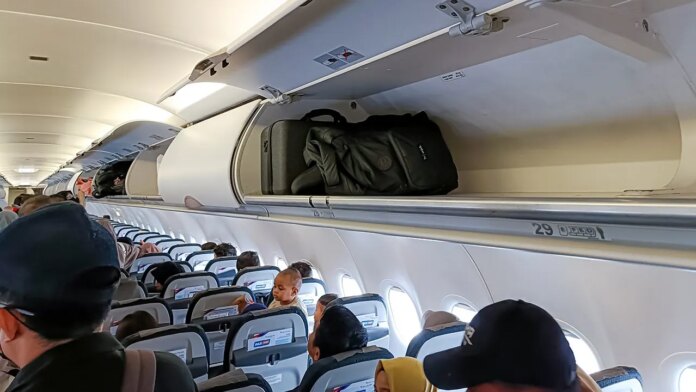 Passengers say airlines are now forcing bag checks despite empty overhead bins