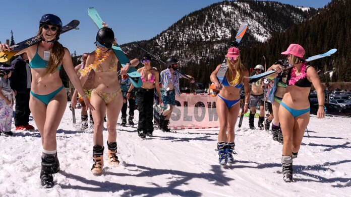 Skiers hit slopes in barely-there bikinis as warm temps melt western resorts' snow